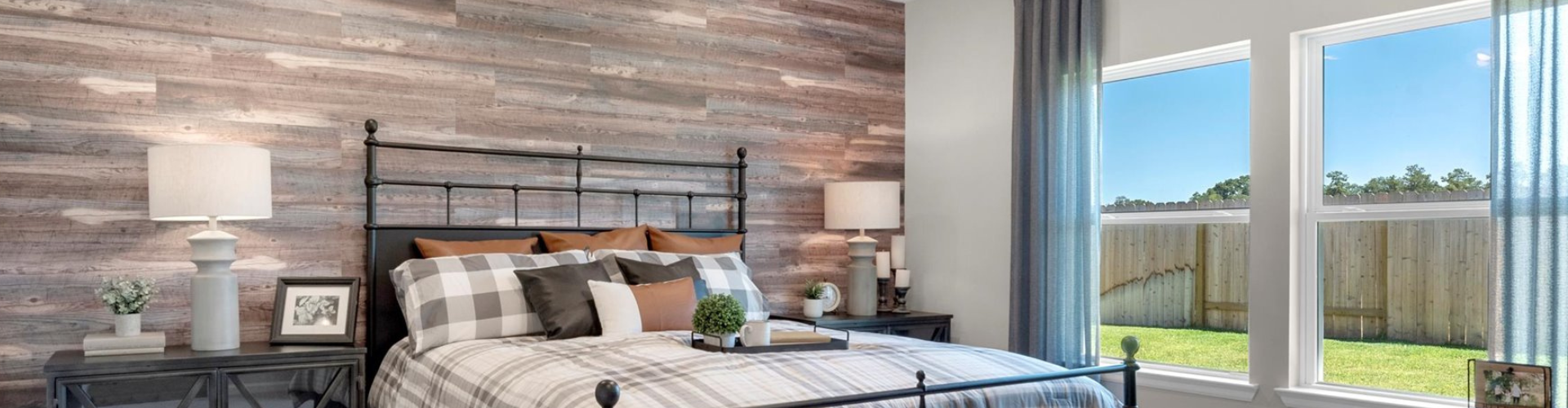 A bedroom with a large window.