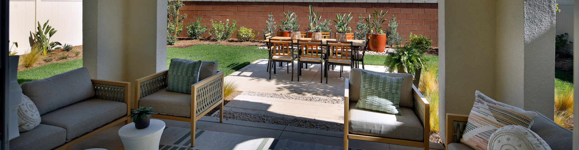 A patio with chairs and a table.
