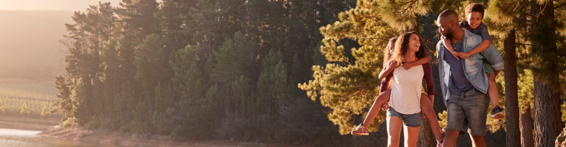 A man and woman walking in the woods.