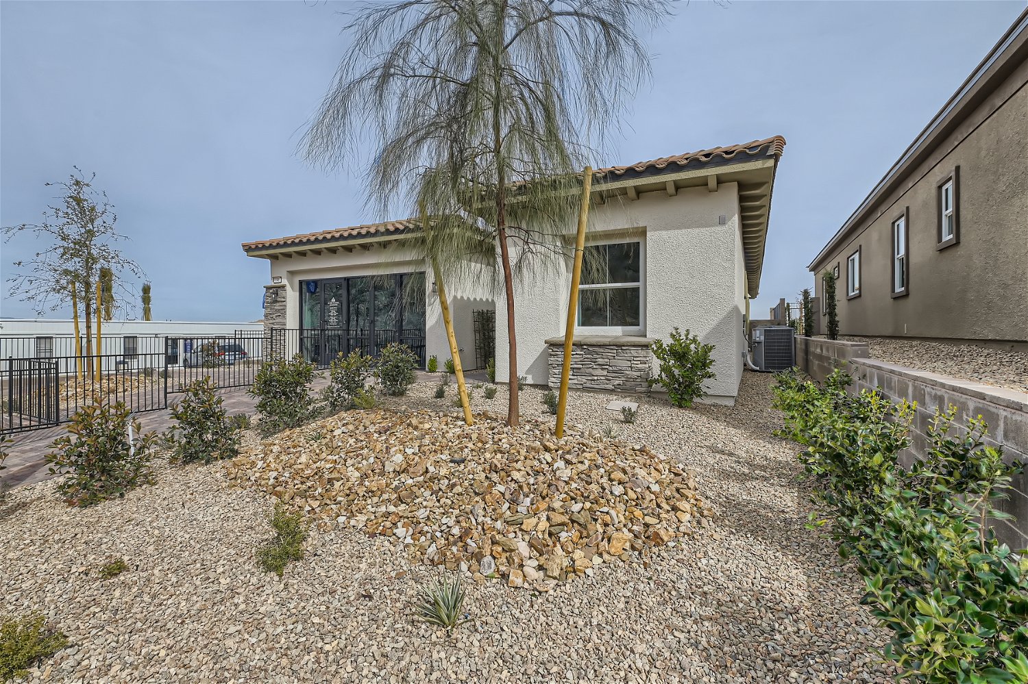 A house with a fence and trees.