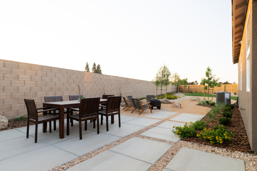 A patio with a table and chairs.