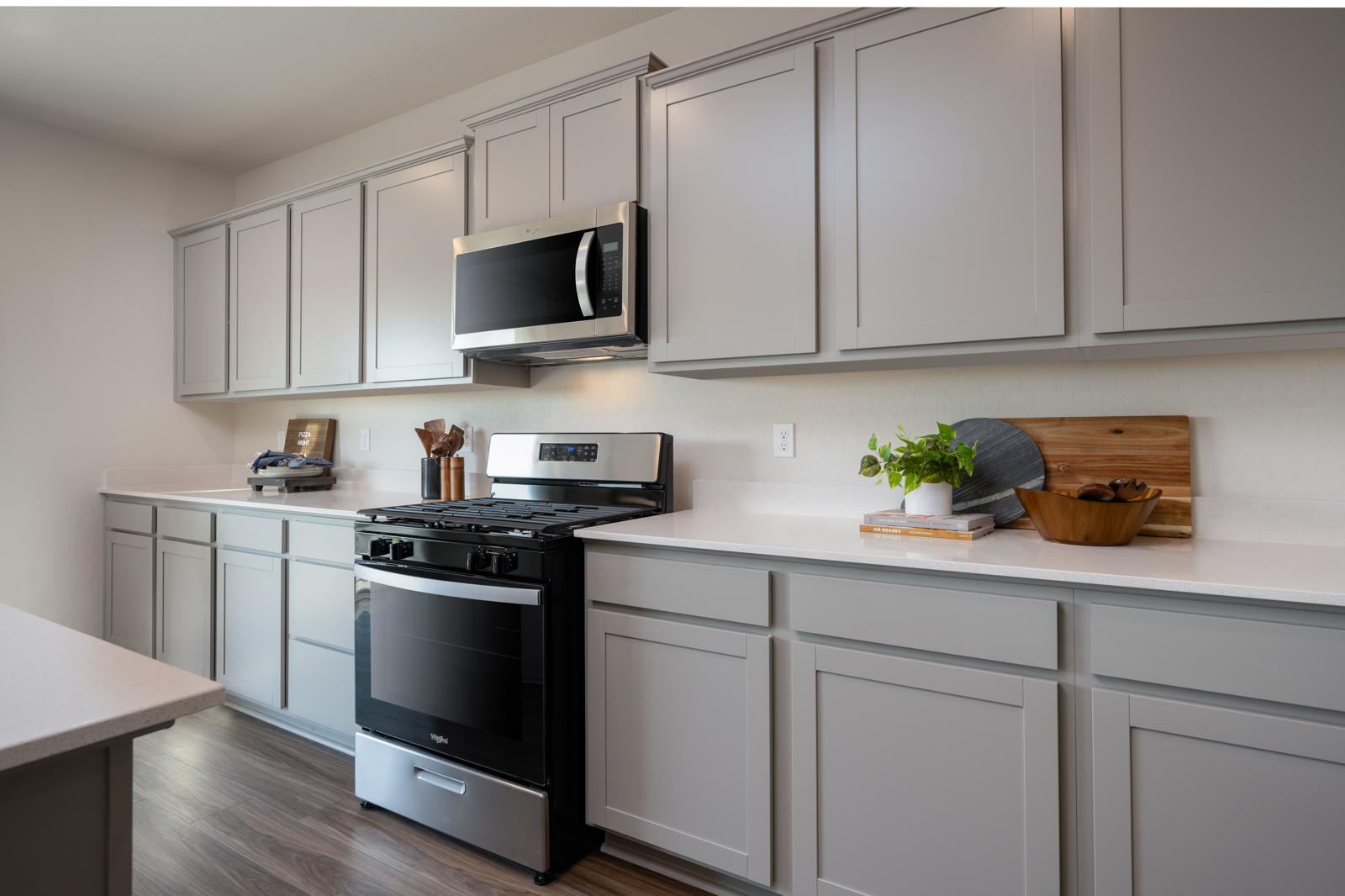 A kitchen with white cabinets.