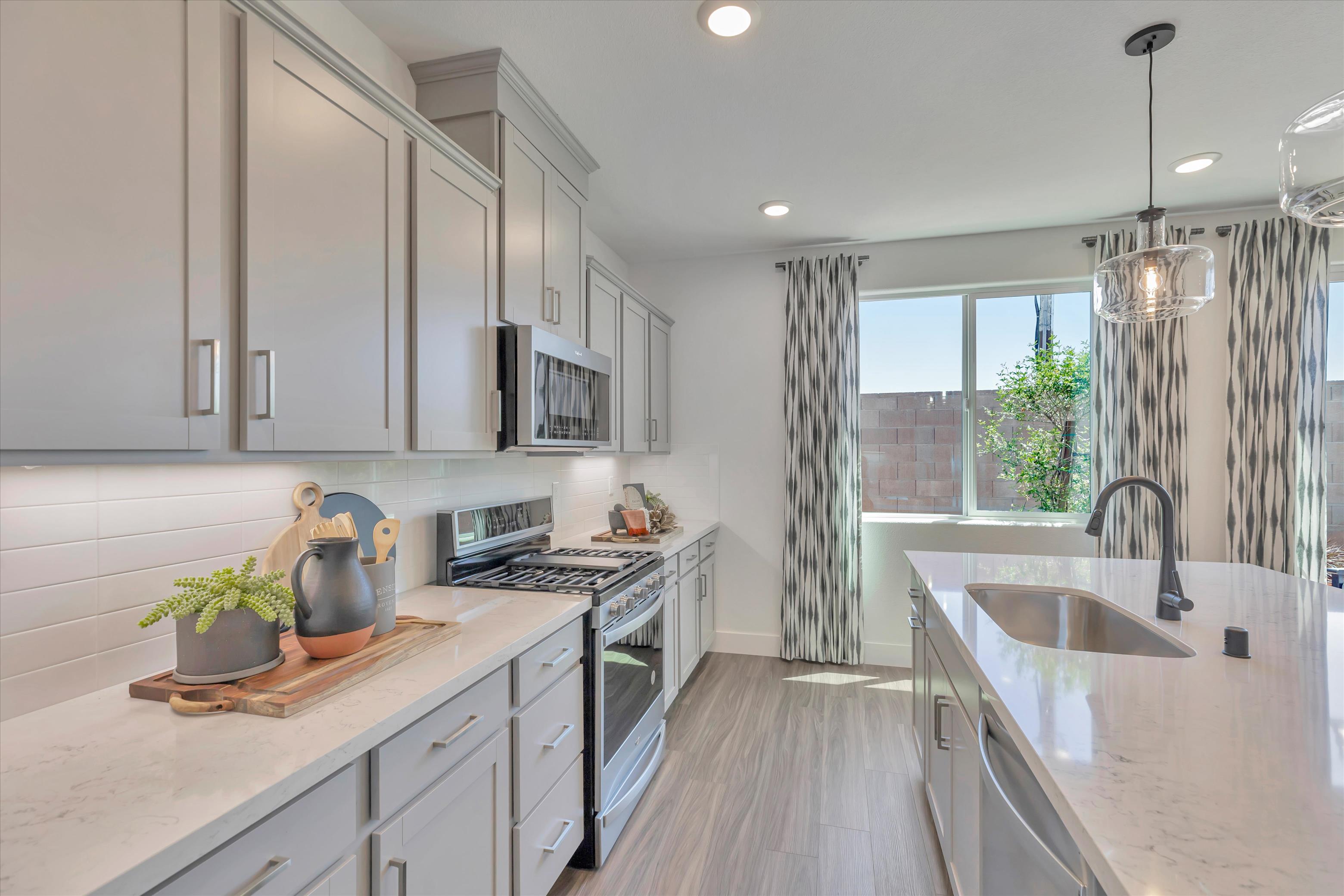 A kitchen with white cabinets.