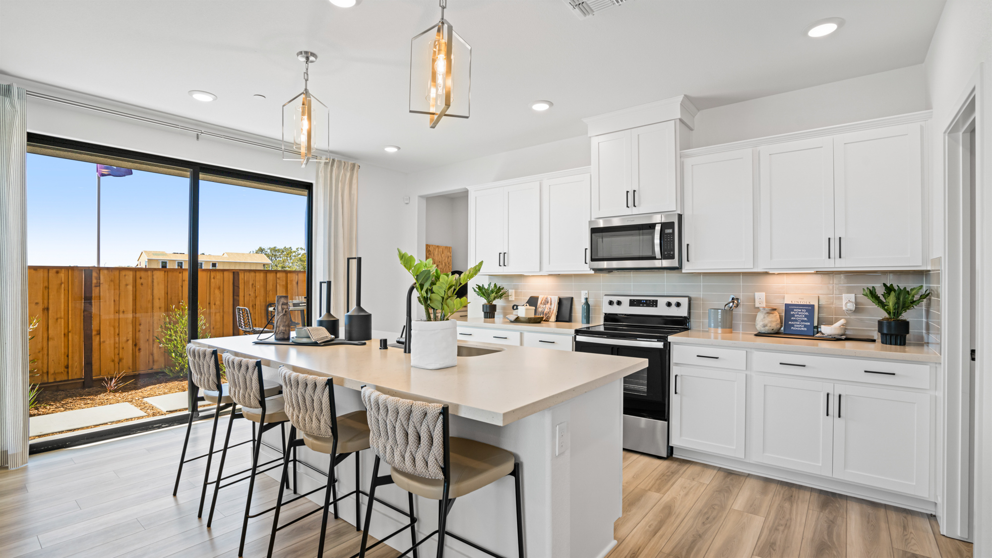 A kitchen with white cabinets.
