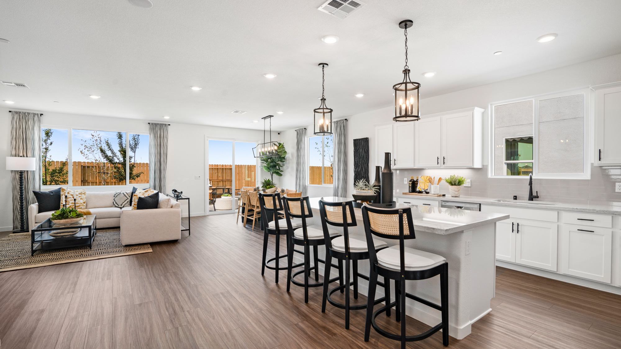 A kitchen with a dining table and chairs.