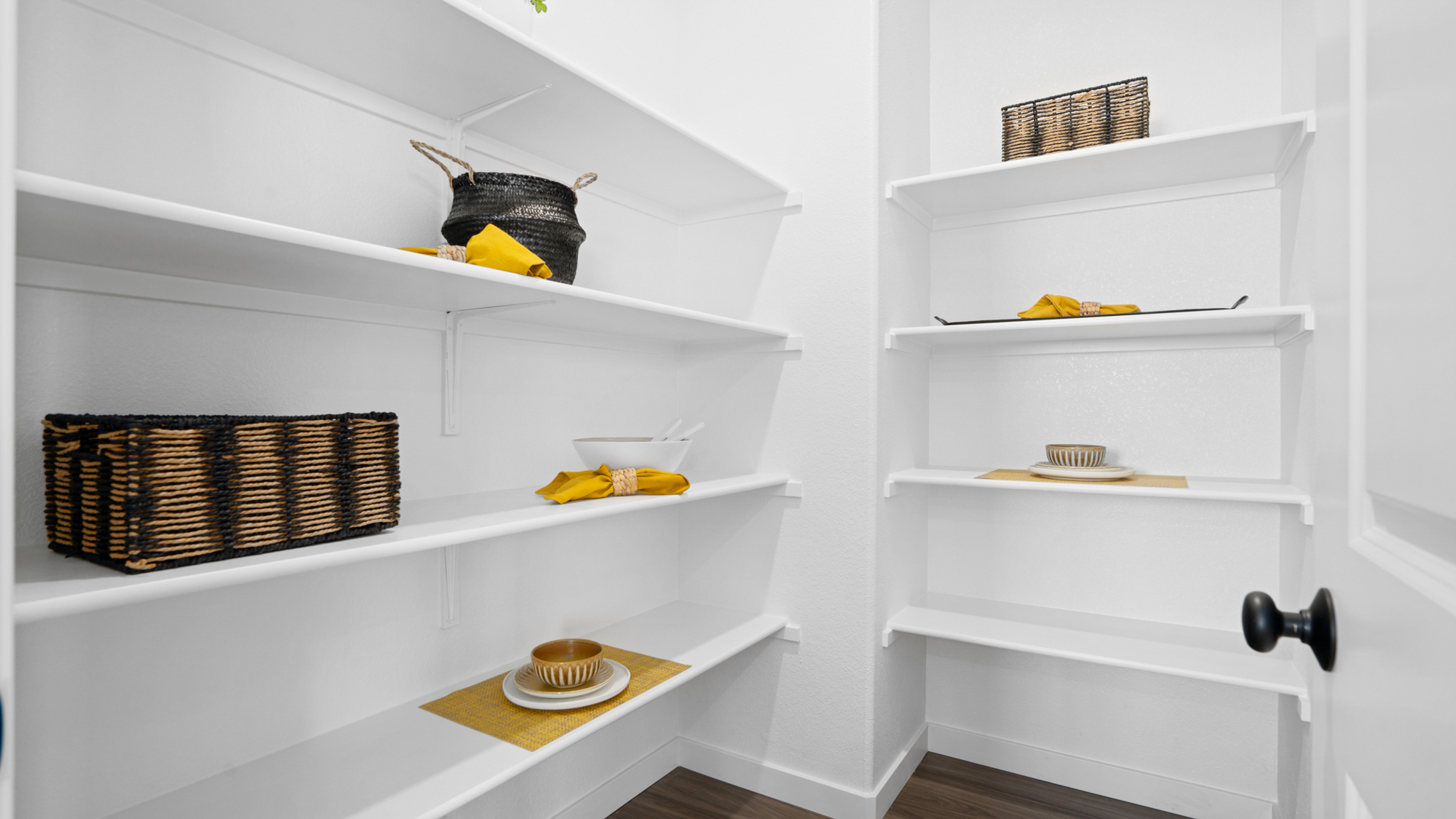 A white shelving unit with baskets and baskets.