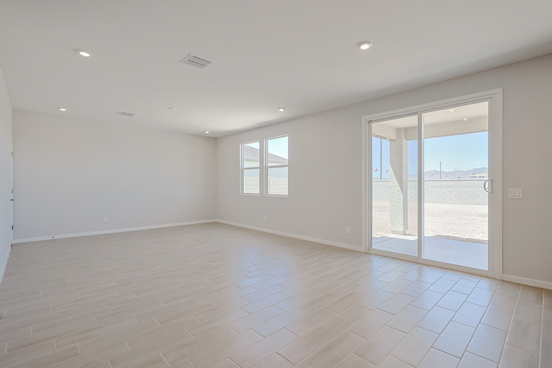 A room with a glass door and a wood floor.