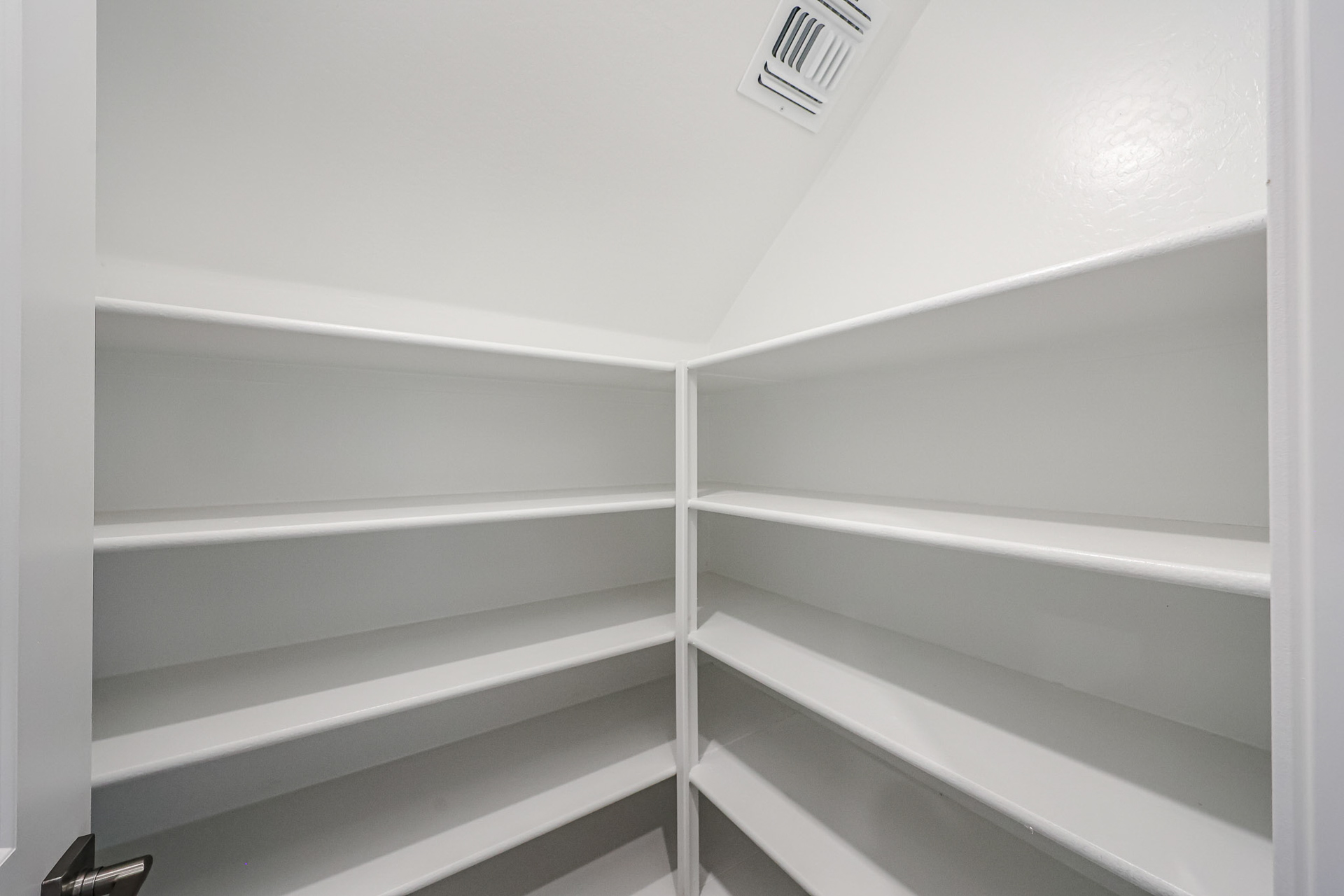 A white shelf with a light.