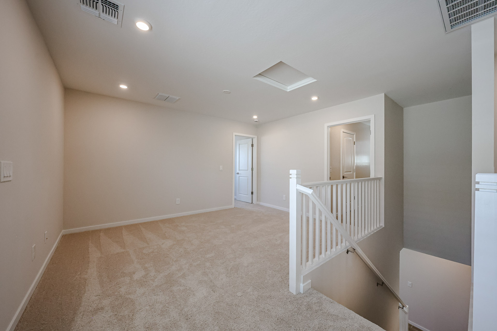 A hallway with white railings.