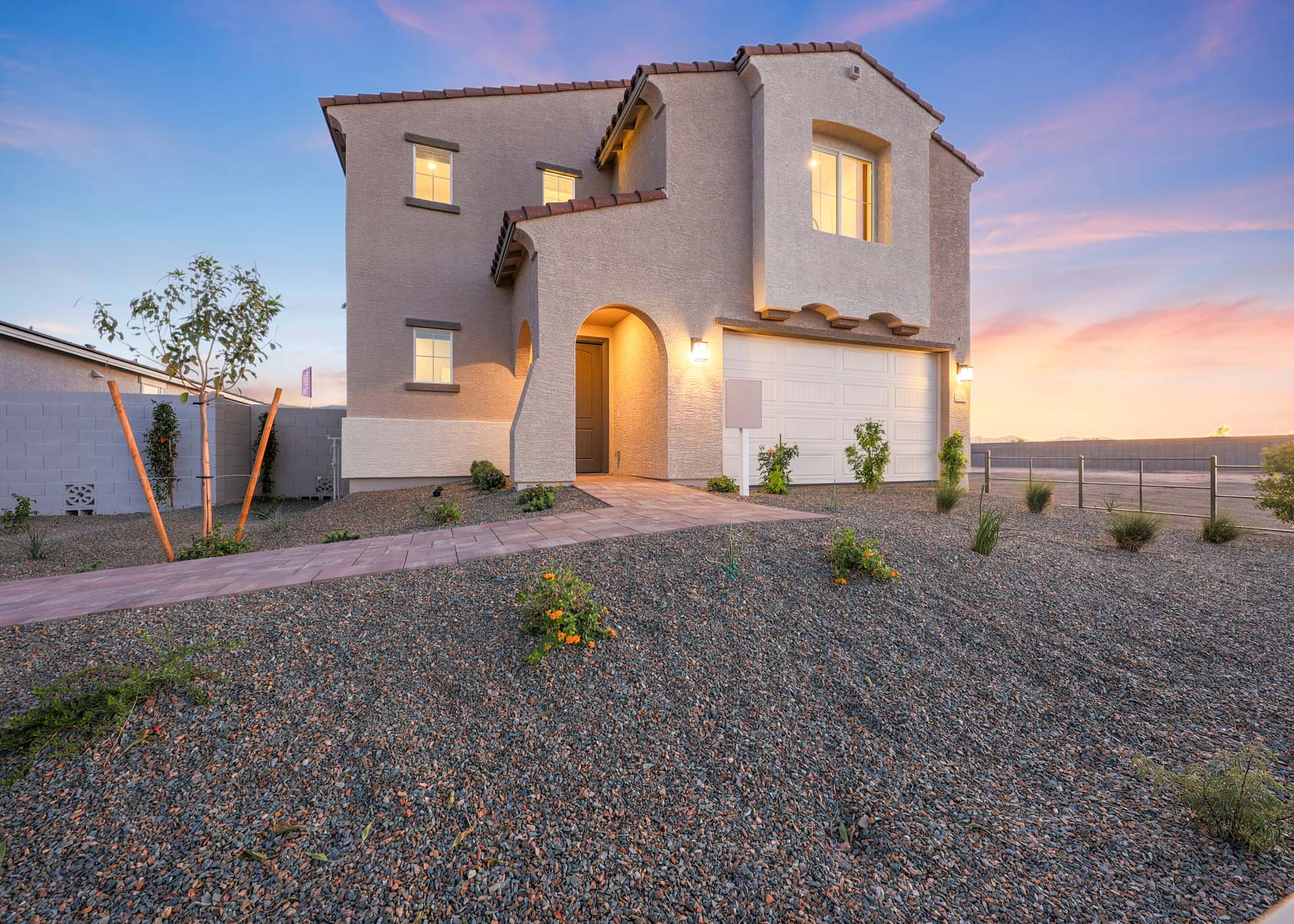 A house with a gravel driveway.