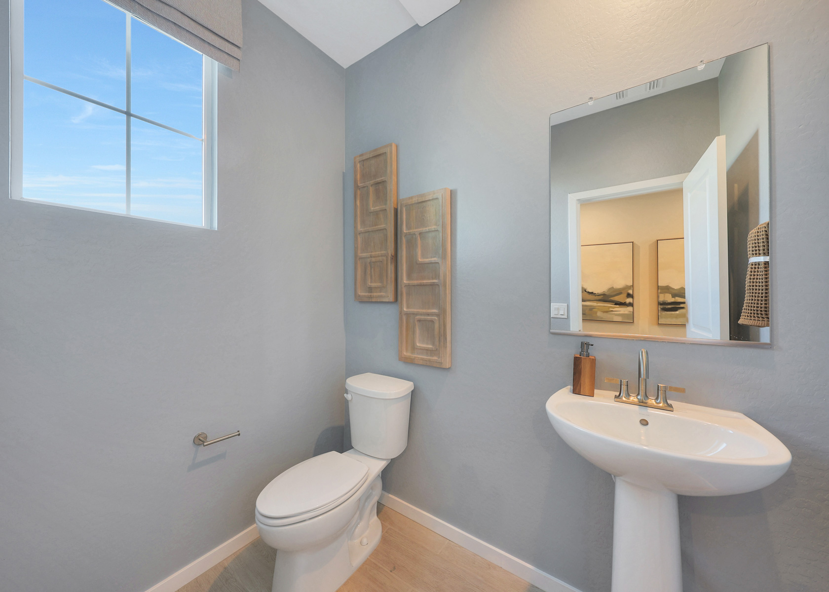 A bathroom with a toilet and sink.