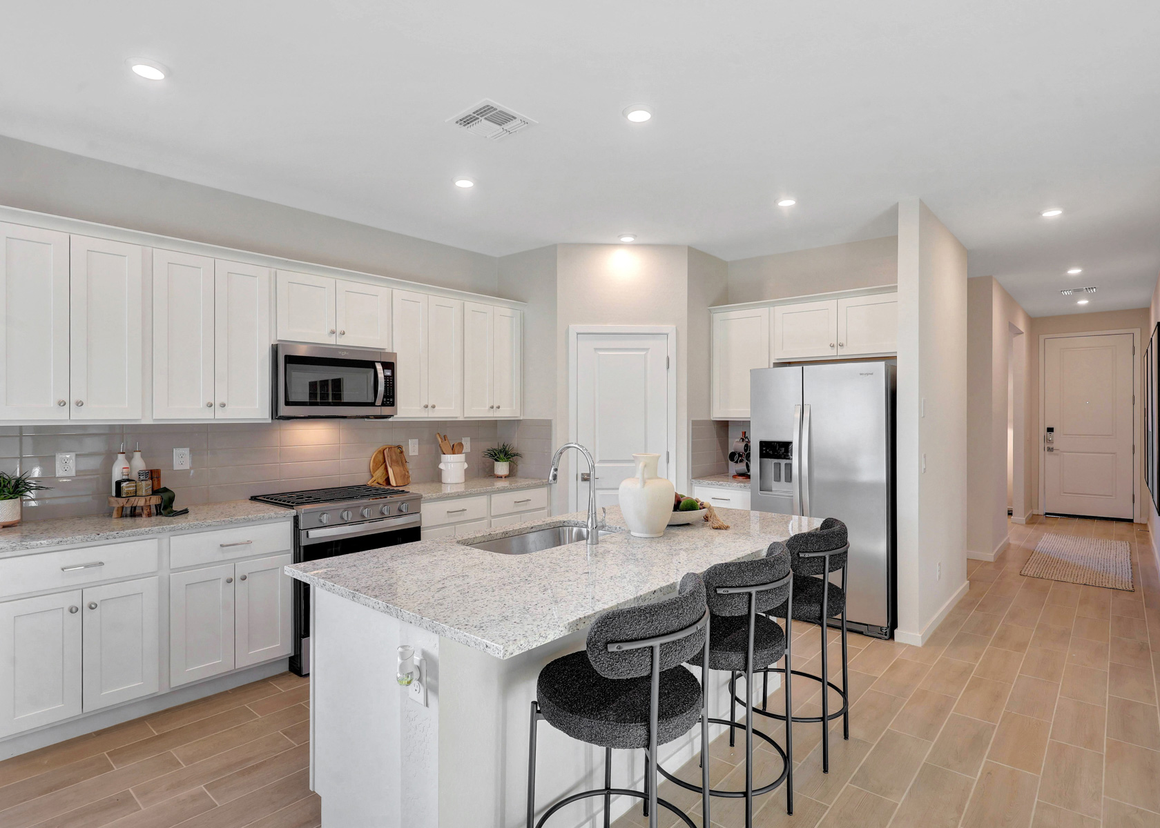 A kitchen with white cabinets.