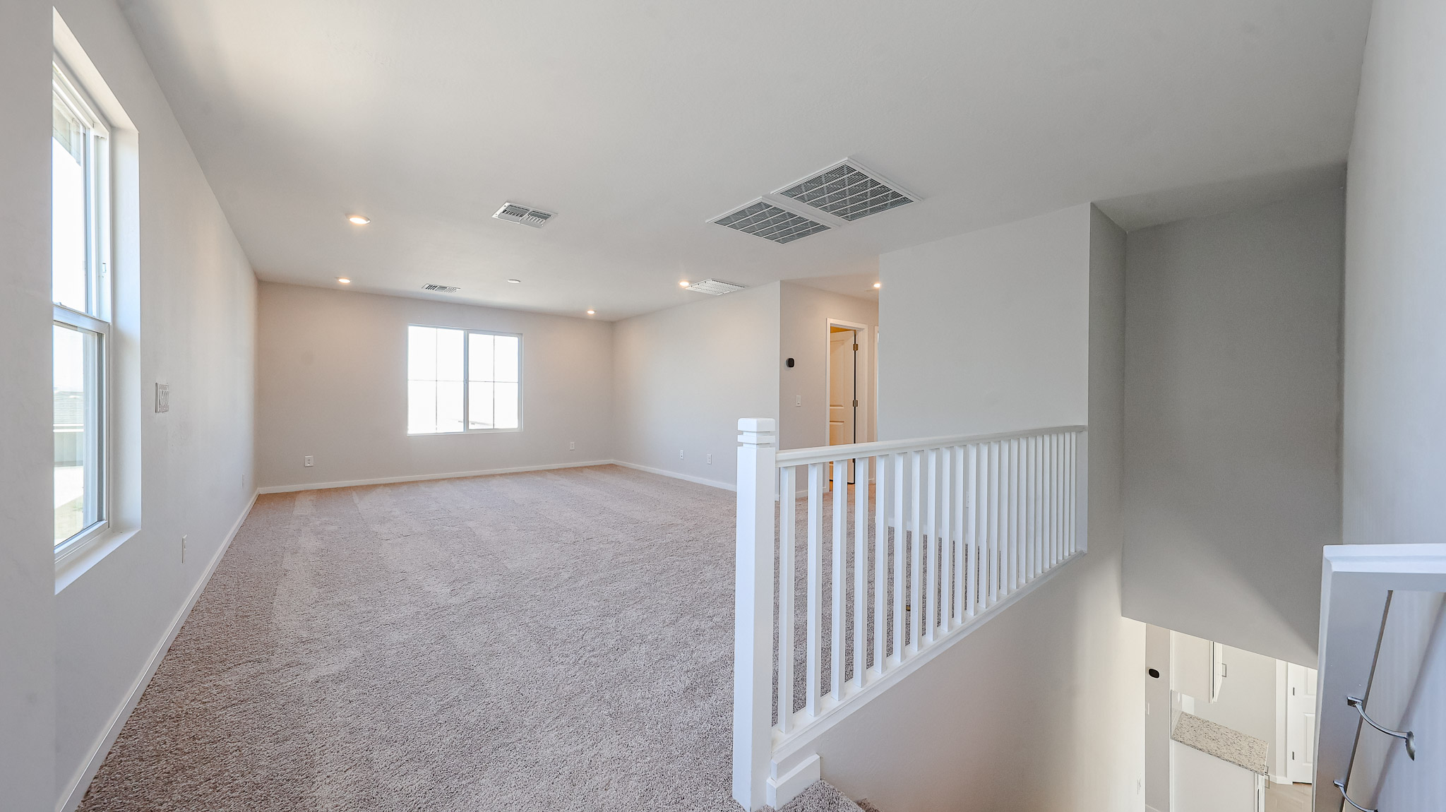 A room with a white railing and a white railing.