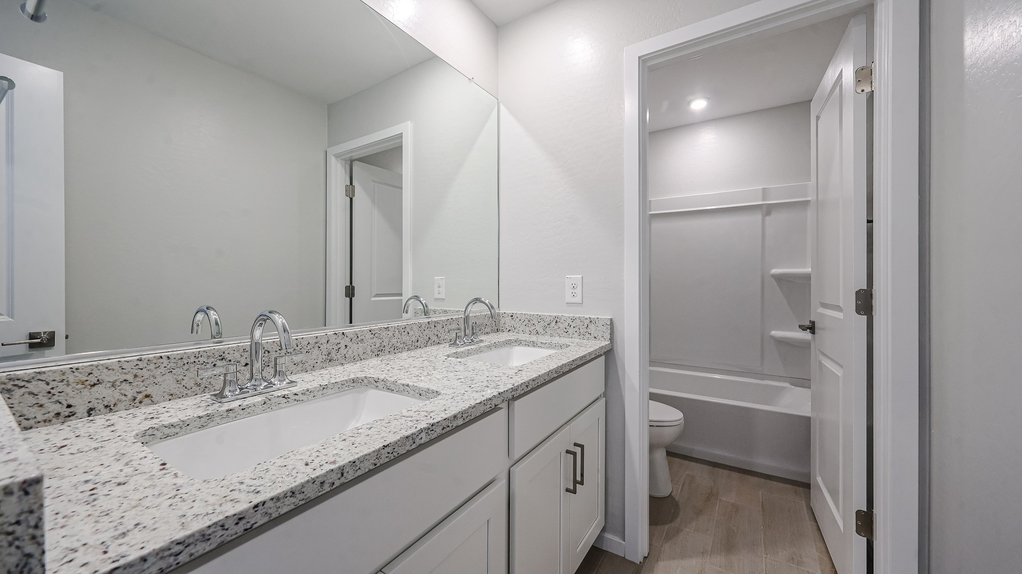 A bathroom with a tub sink and toilet.