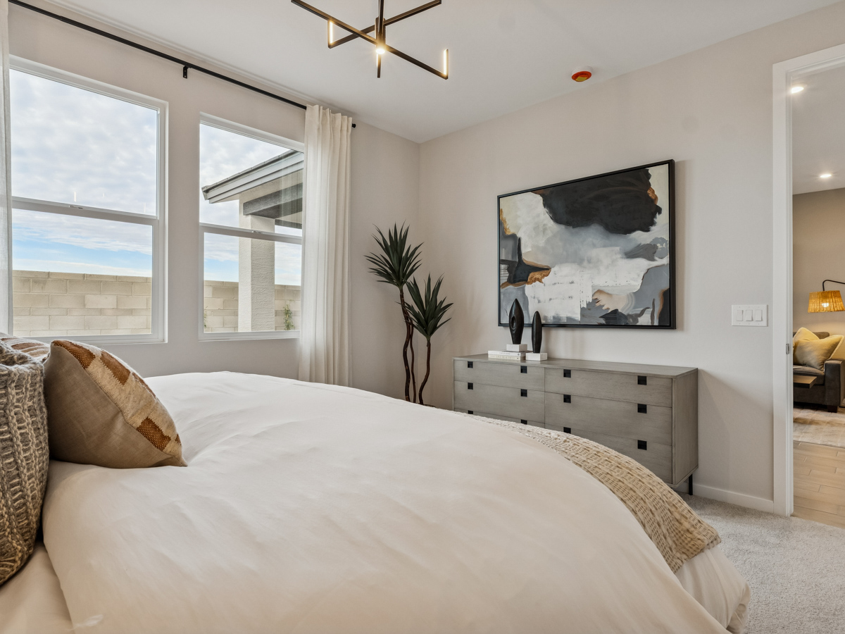 A bedroom with a large window.