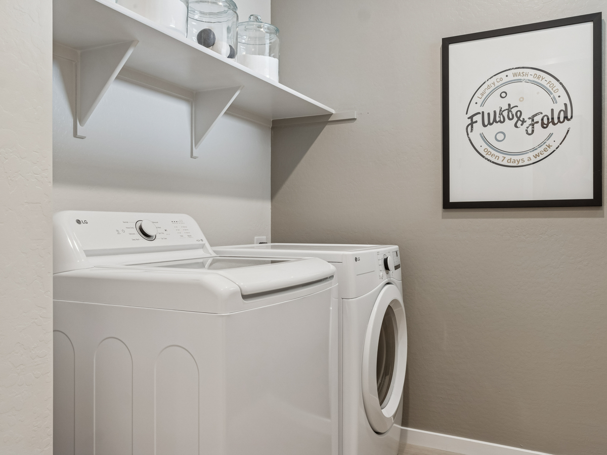 A washing machine in a room.