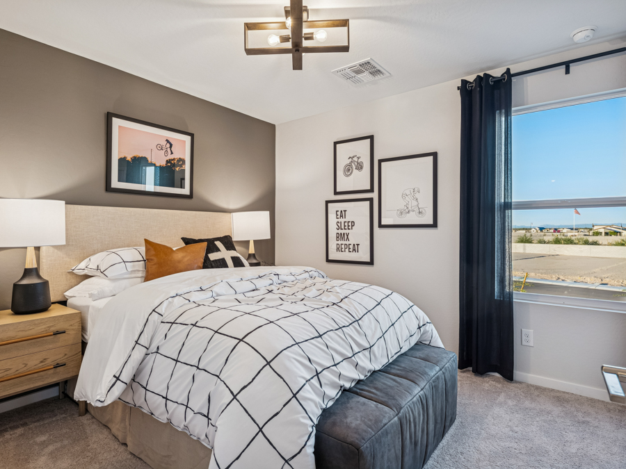 A bedroom with a large window.