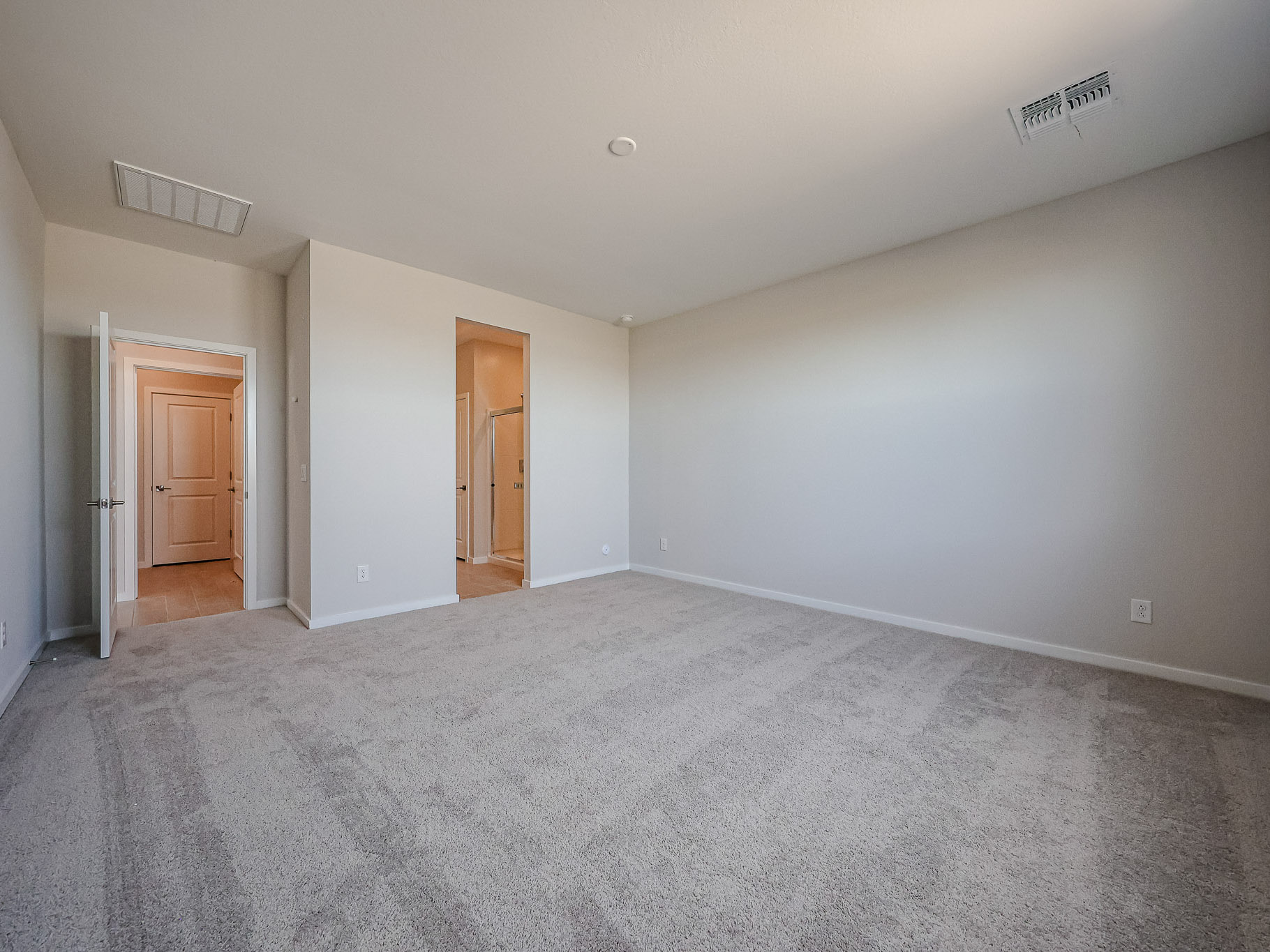 A room with carpet and a door.