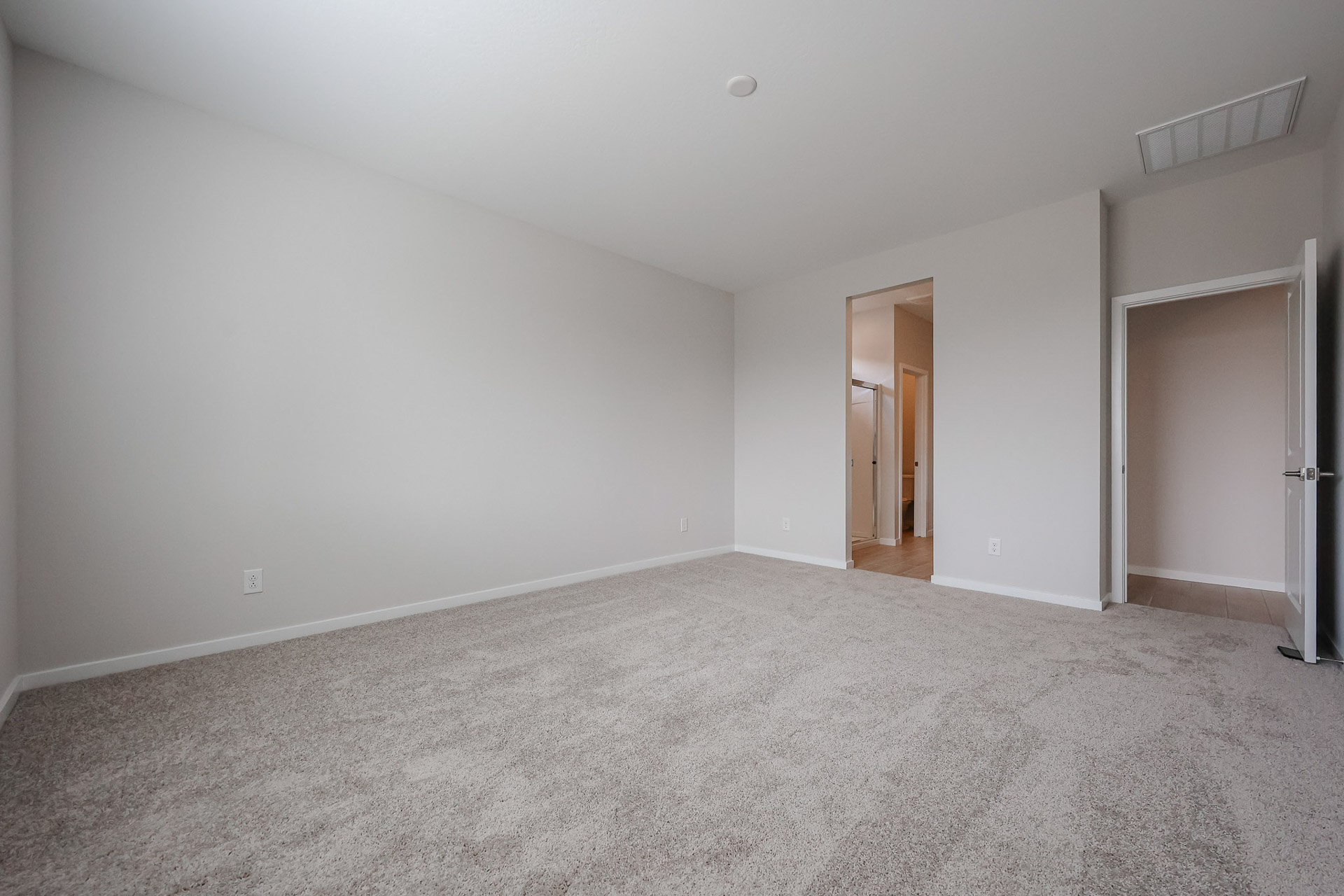 A room with carpet and a door.