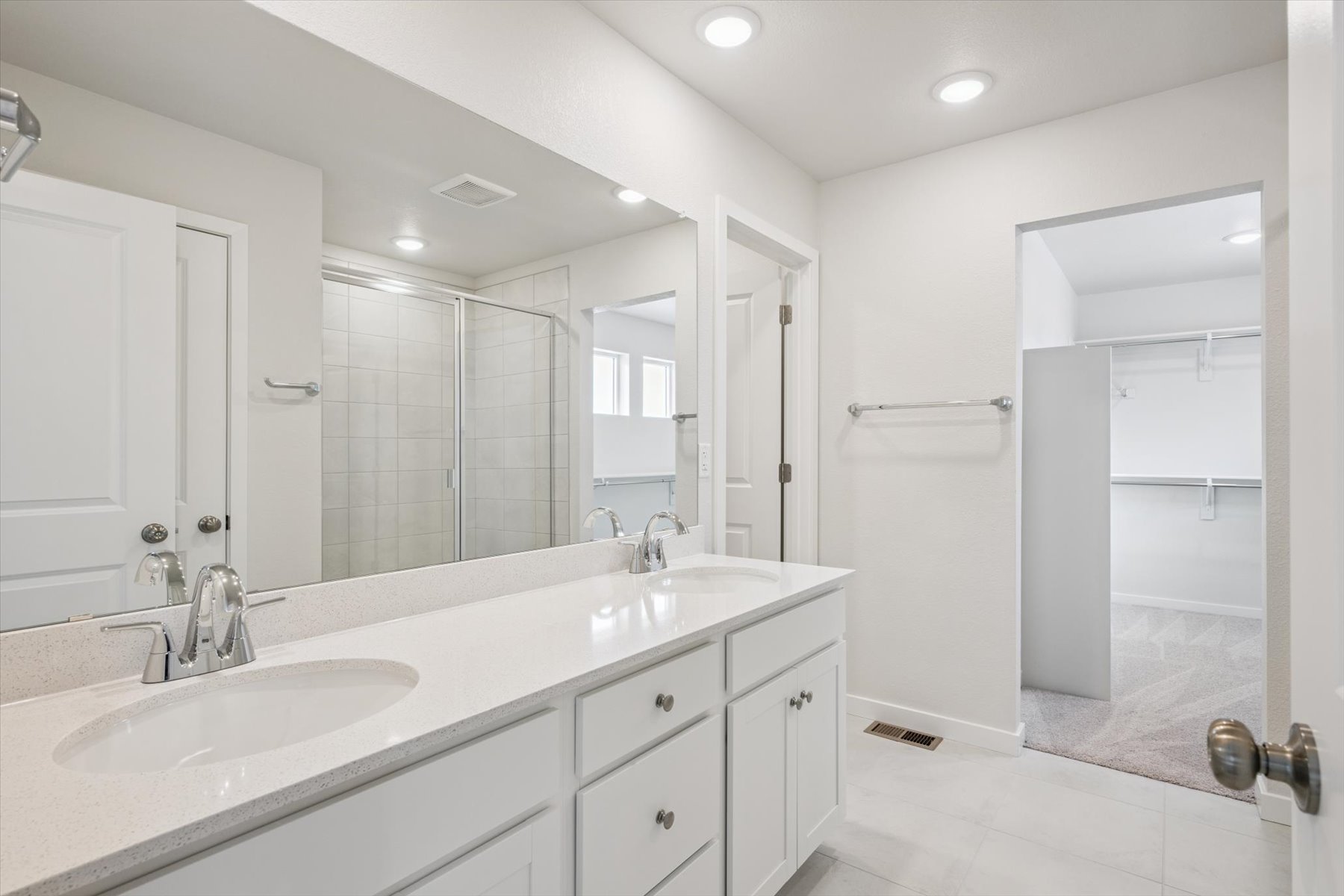 A bathroom with a large mirror.