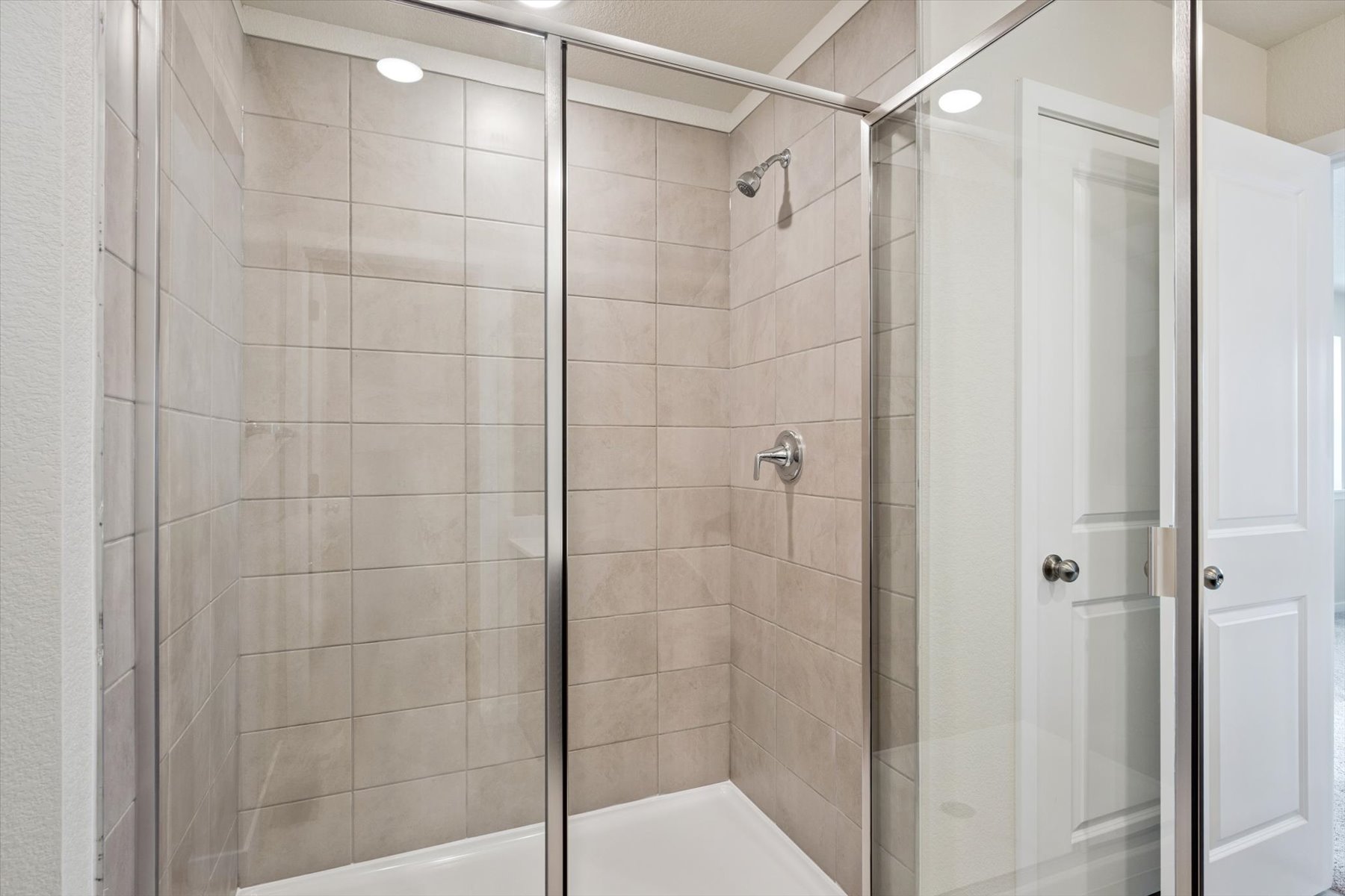 A shower with a glass door.