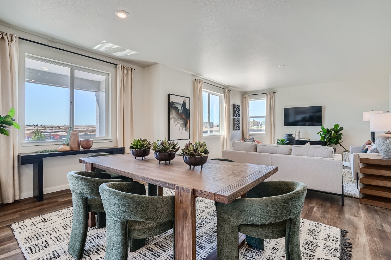 A dining room with a large table.