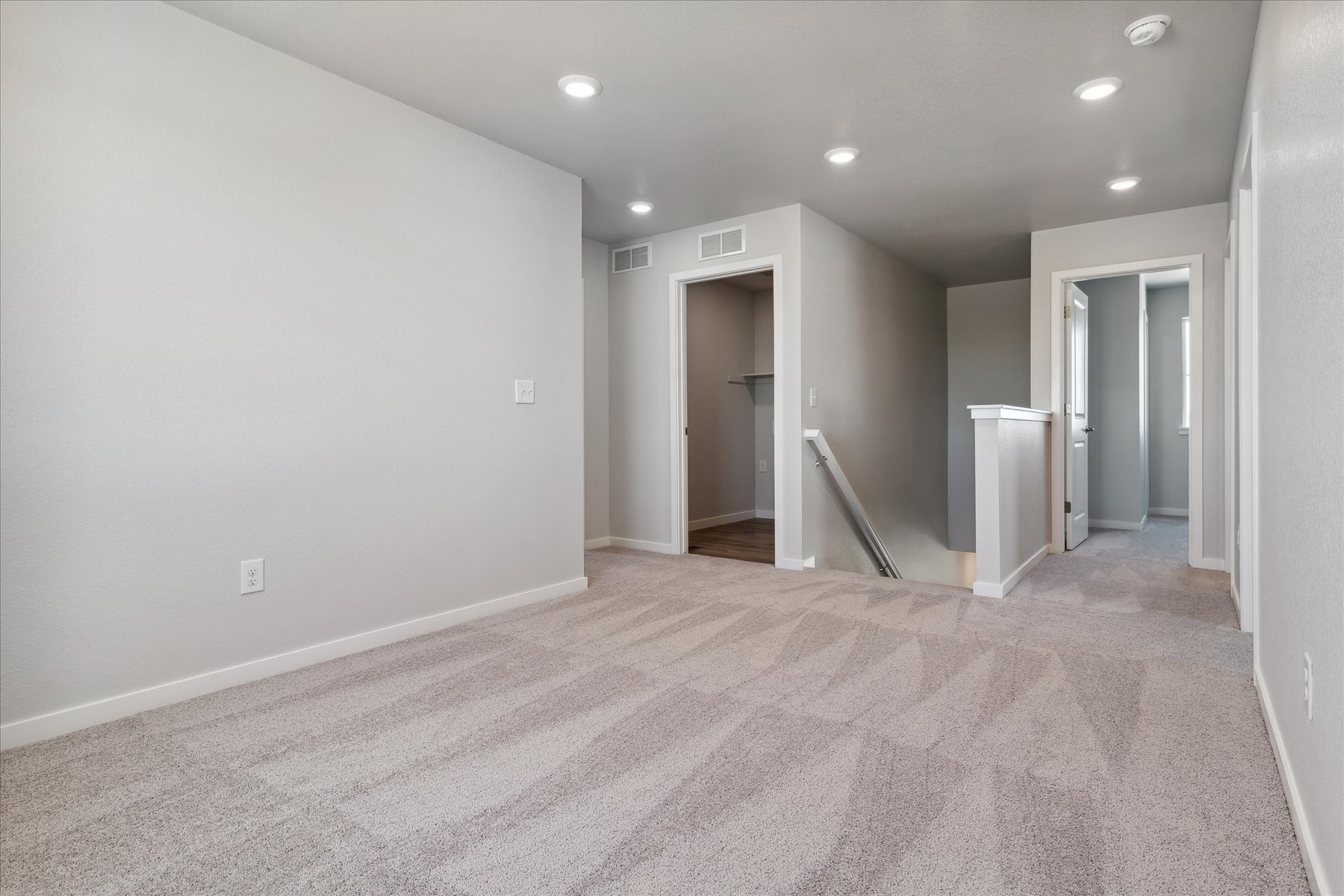 A hallway with white walls.