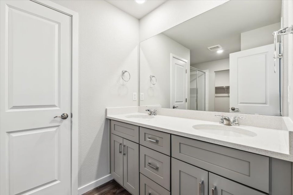 A bathroom with a large mirror.