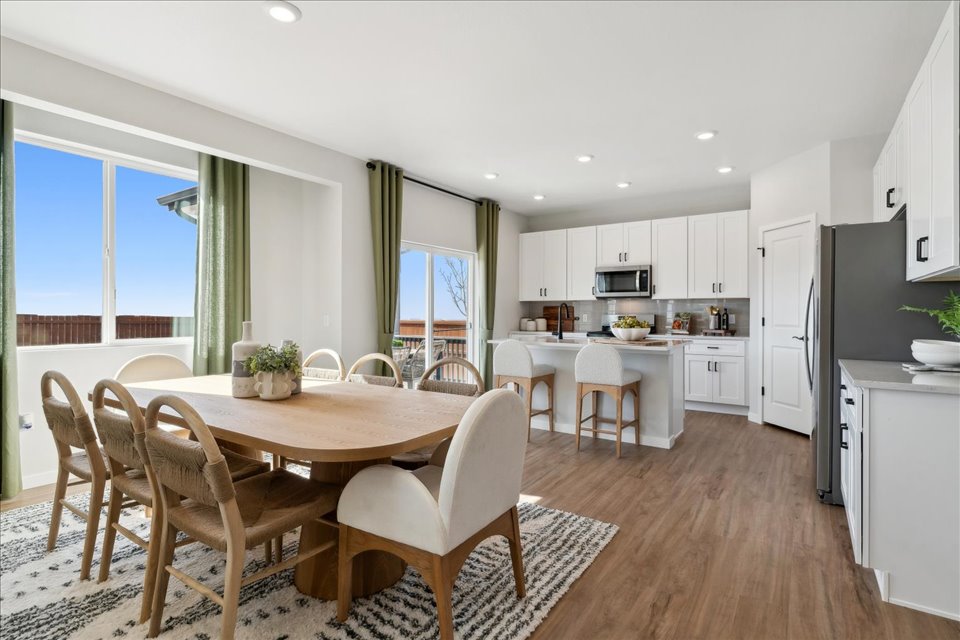 A kitchen with a dining table.