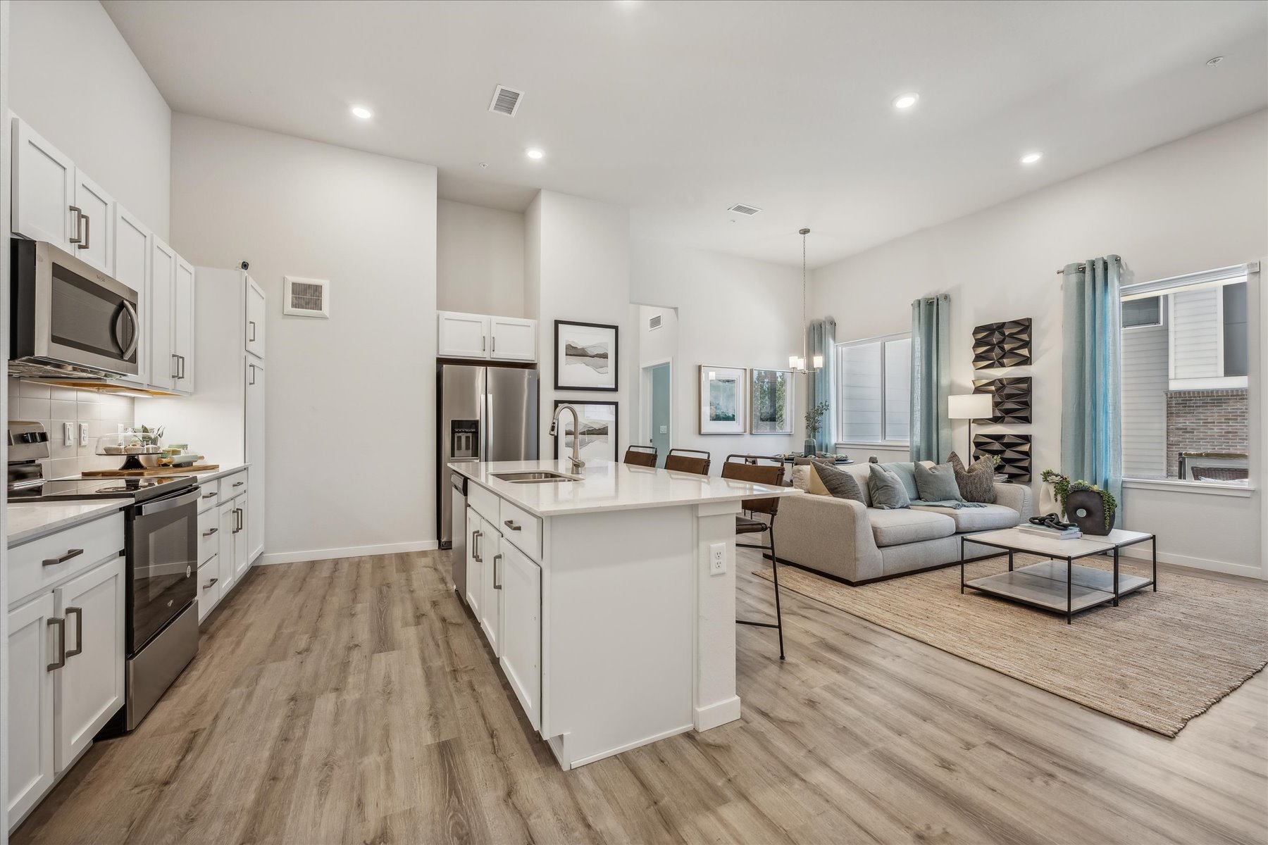 A large kitchen with a wood floor.