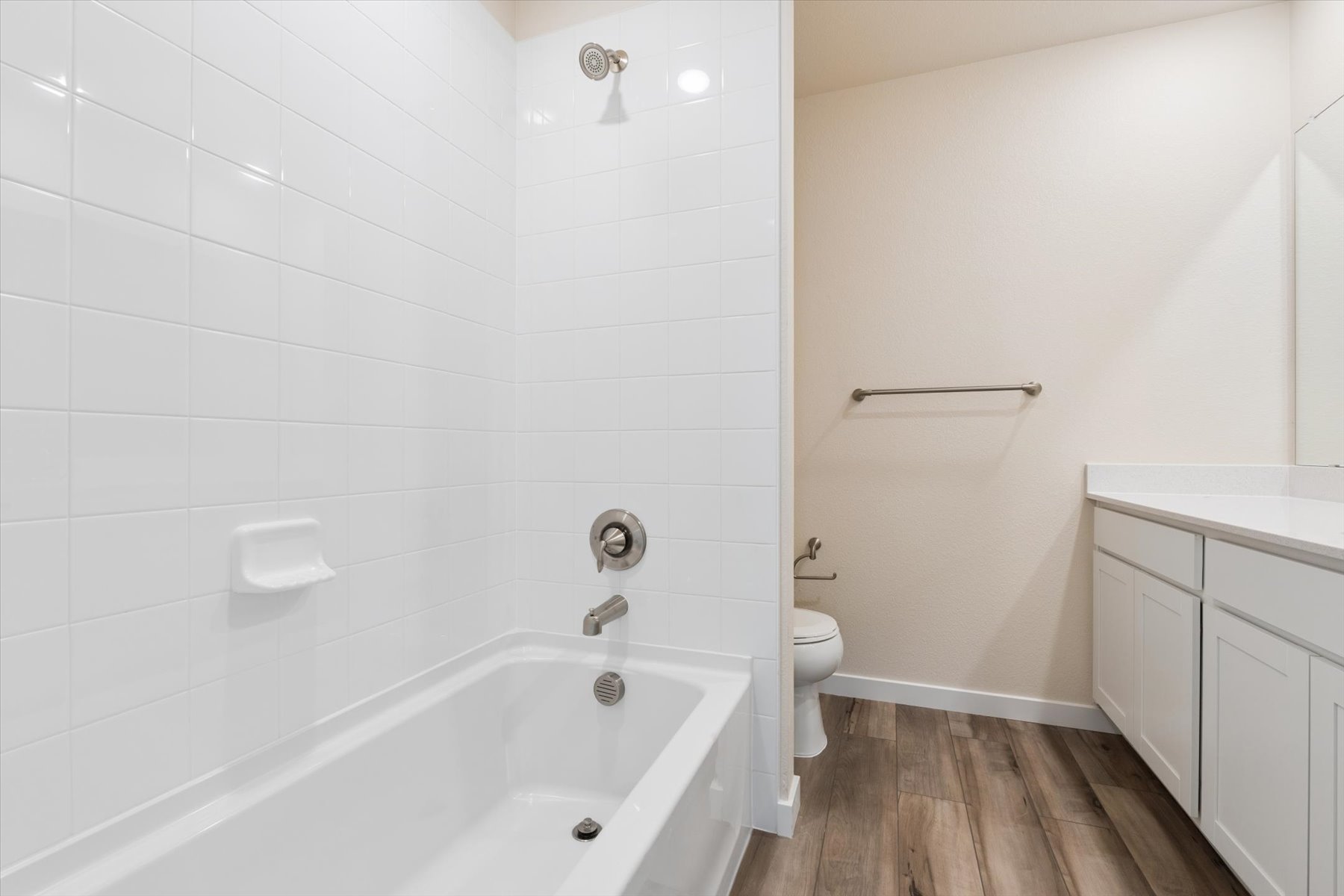 A bathroom with a tub toilet and sink.