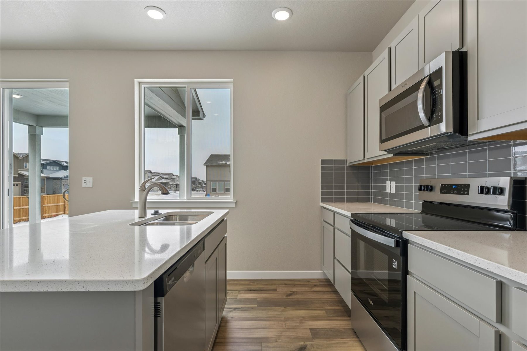 A kitchen with white cabinets.