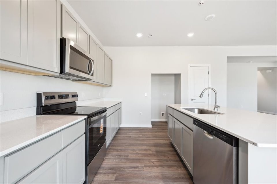 A kitchen with white cabinets.