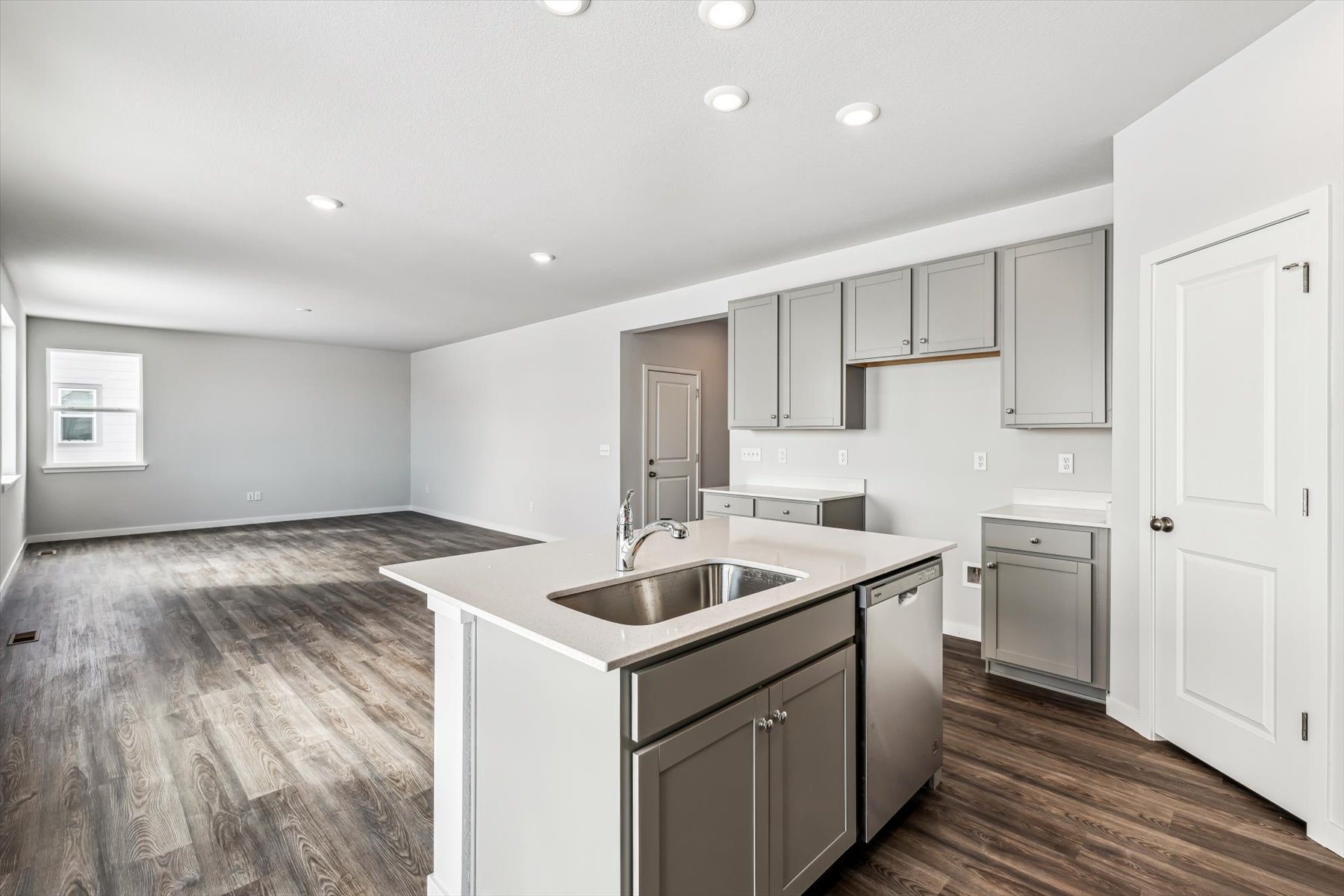 A kitchen with white cabinets.