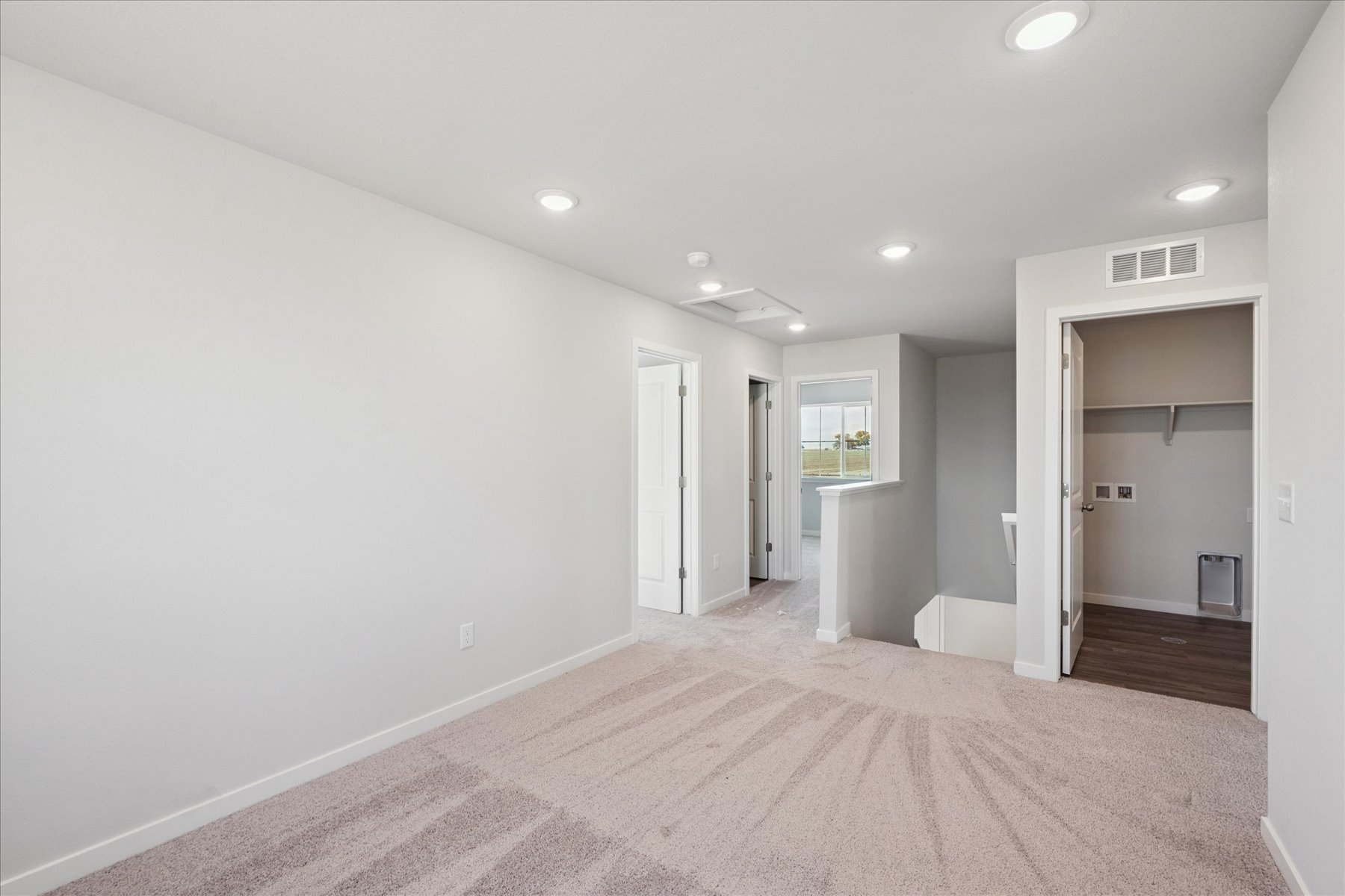 A long hallway with white walls.