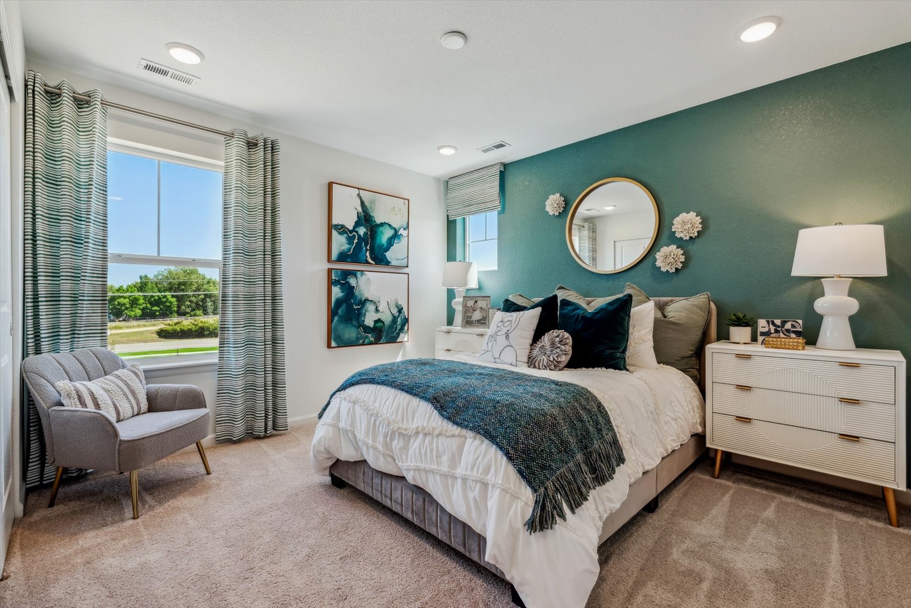 A bedroom with a bed and a chair.