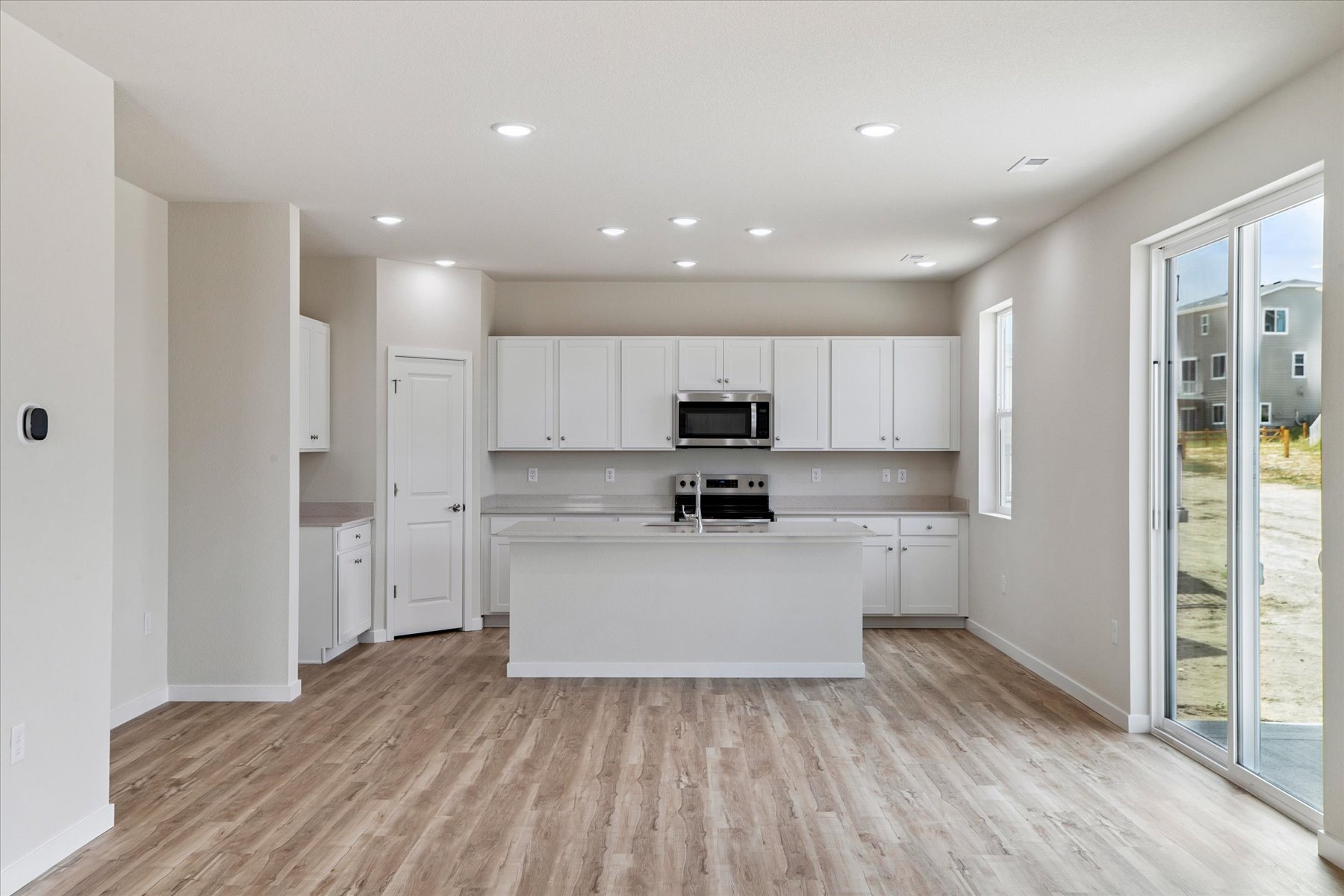 A large kitchen with white cabinets.
