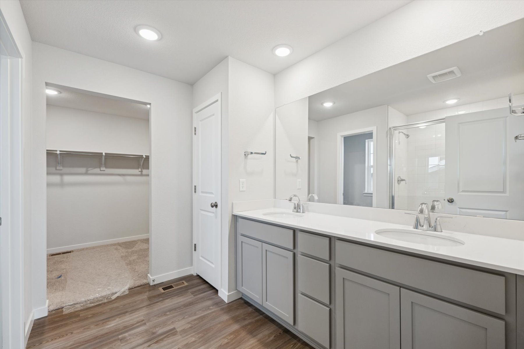 A bathroom with white cabinets.