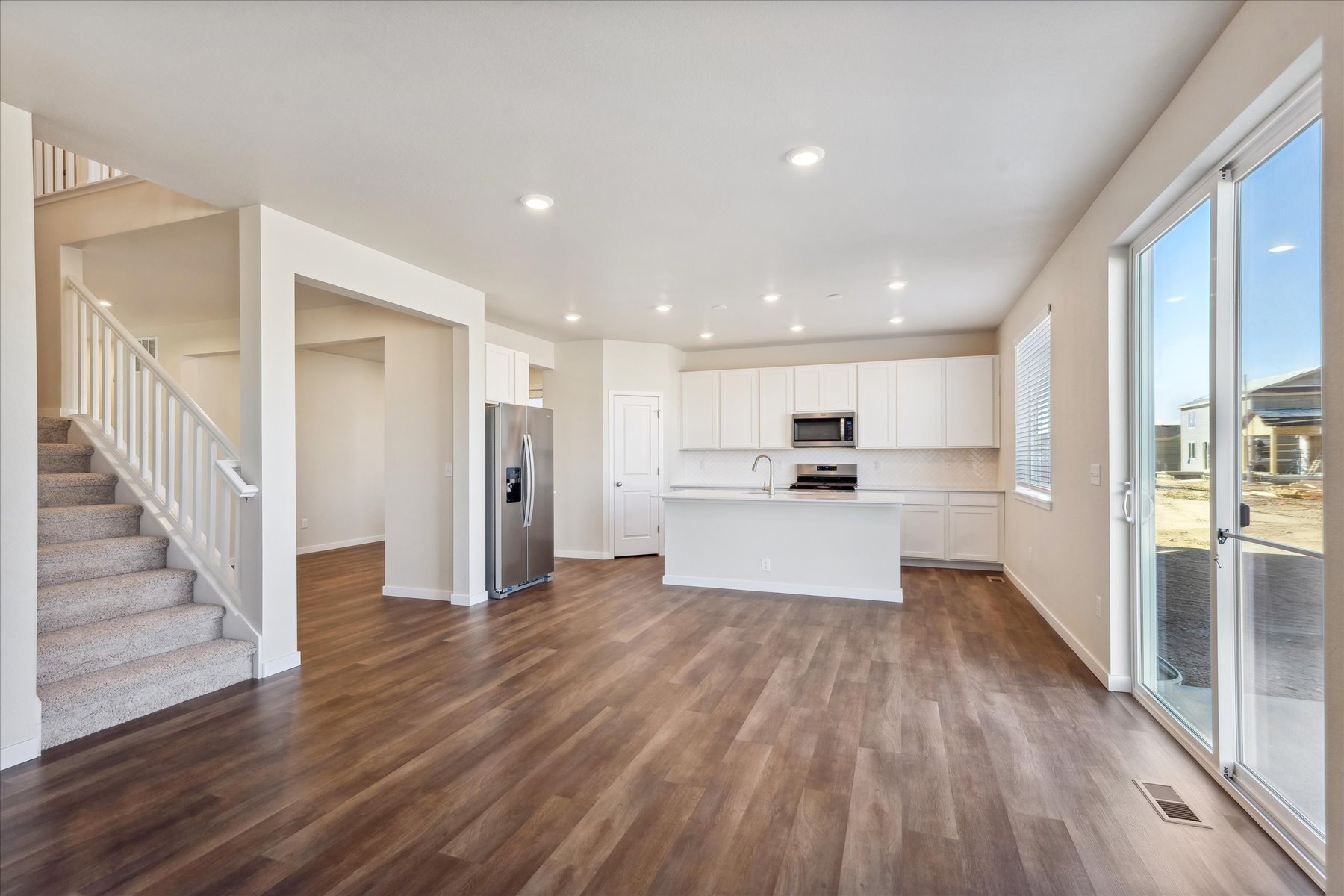 A large kitchen with white cabinets.
