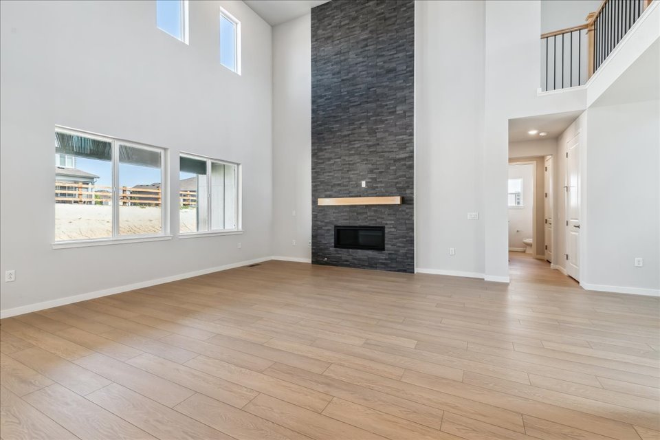 A room with a fireplace and a wood floor.