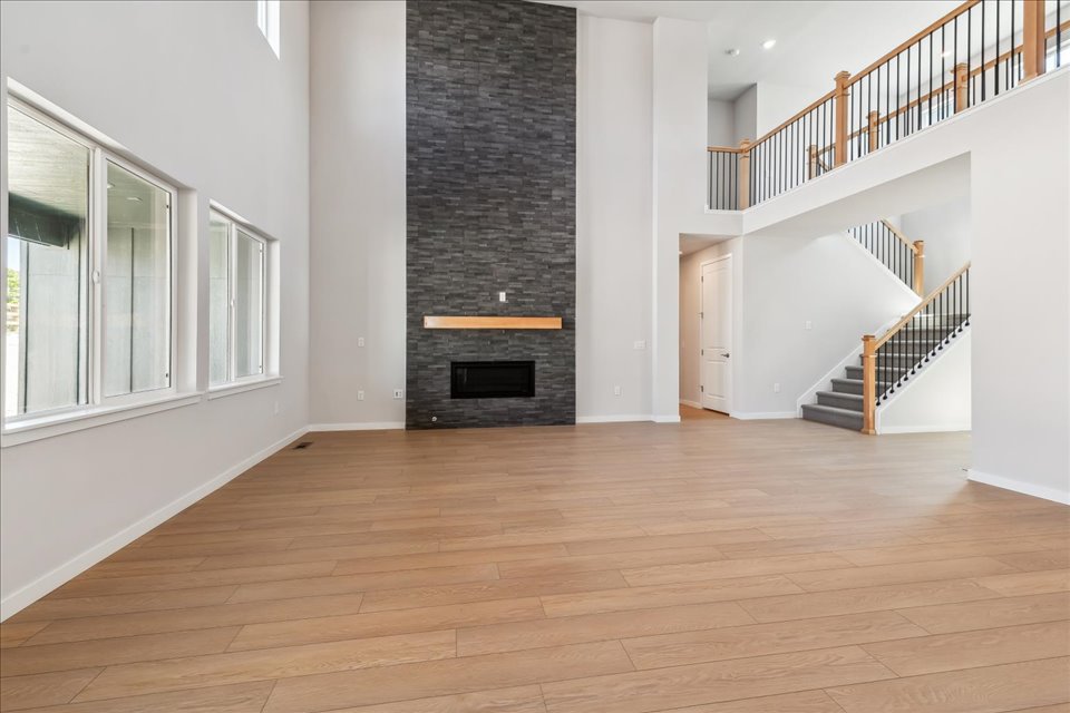 A room with a fireplace and a wood floor.