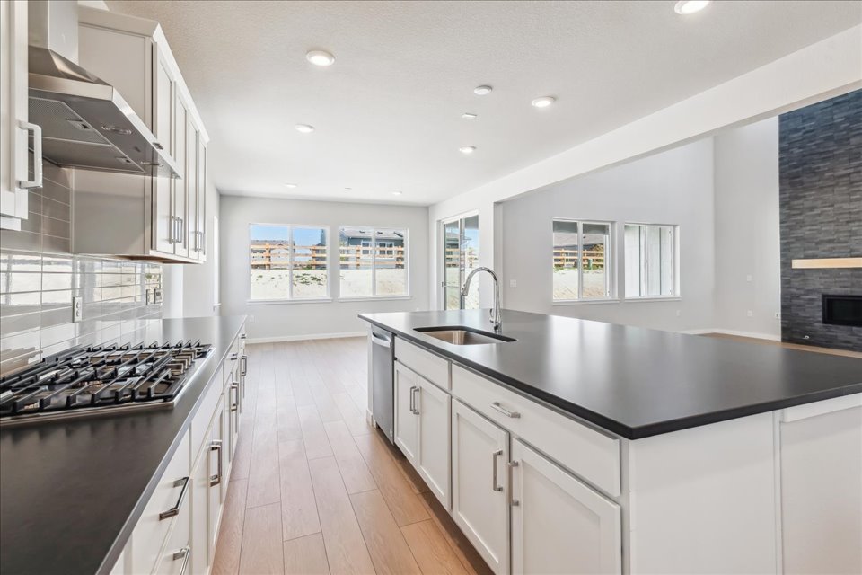 A kitchen with white cabinets.