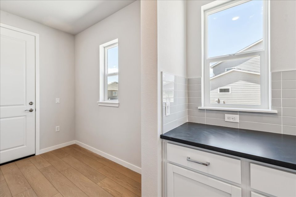 A kitchen with white cabinets.