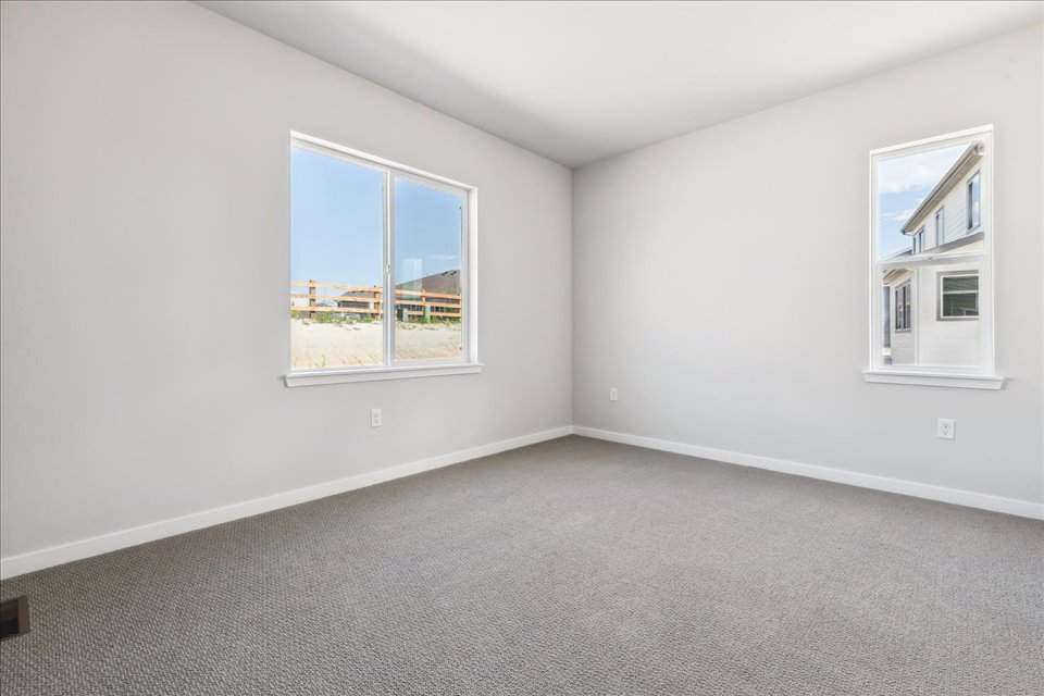 A room with a window and a carpet.