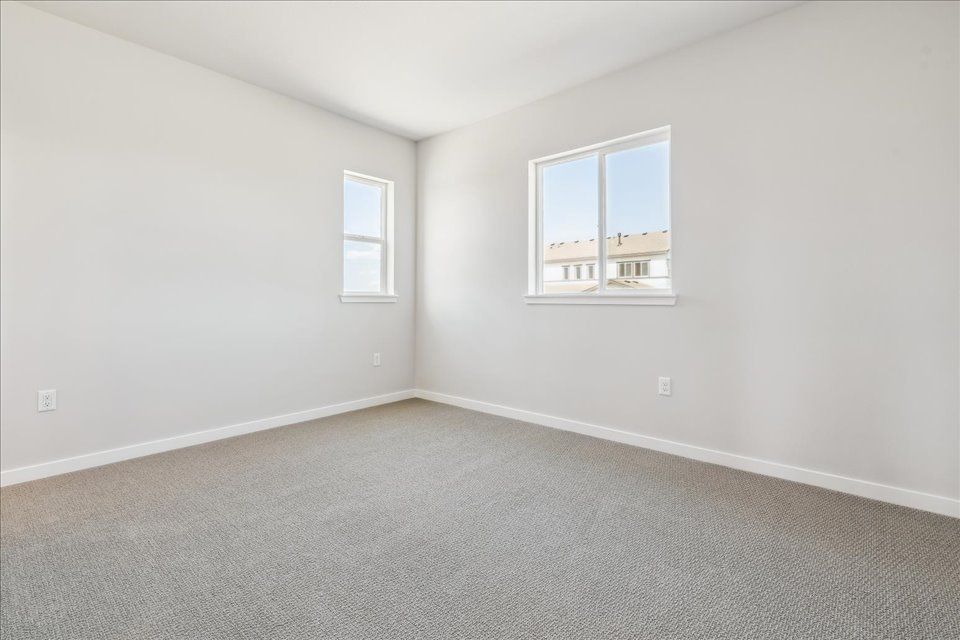 A room with a window and a carpet.