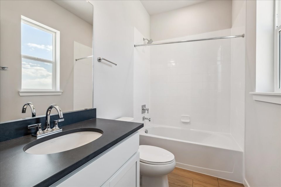 A bathroom with a sink and a tub.