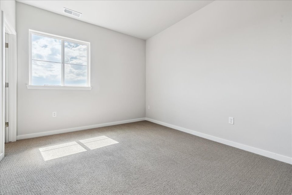 A room with a window and a door.