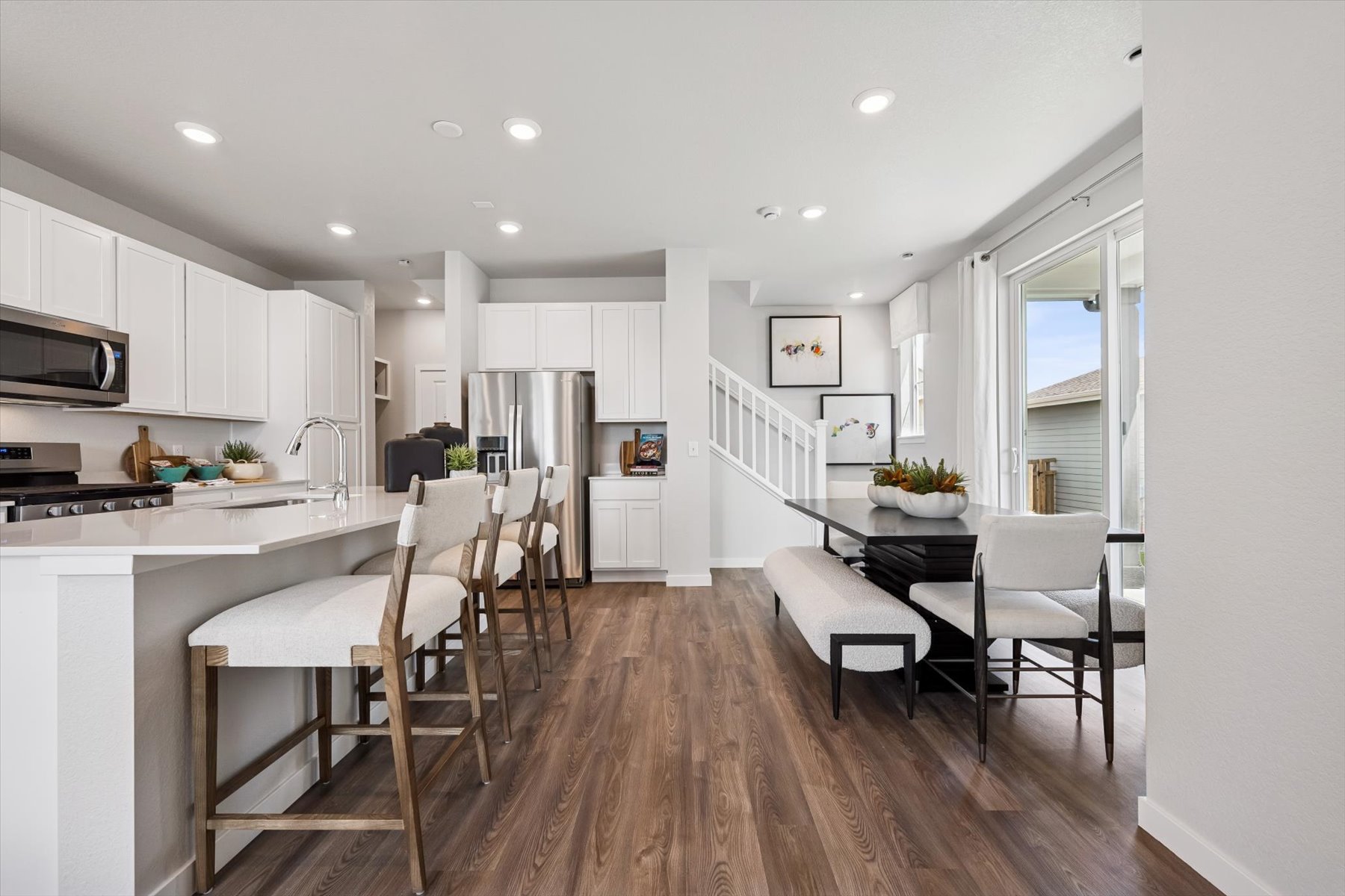 A kitchen with white cabinets.