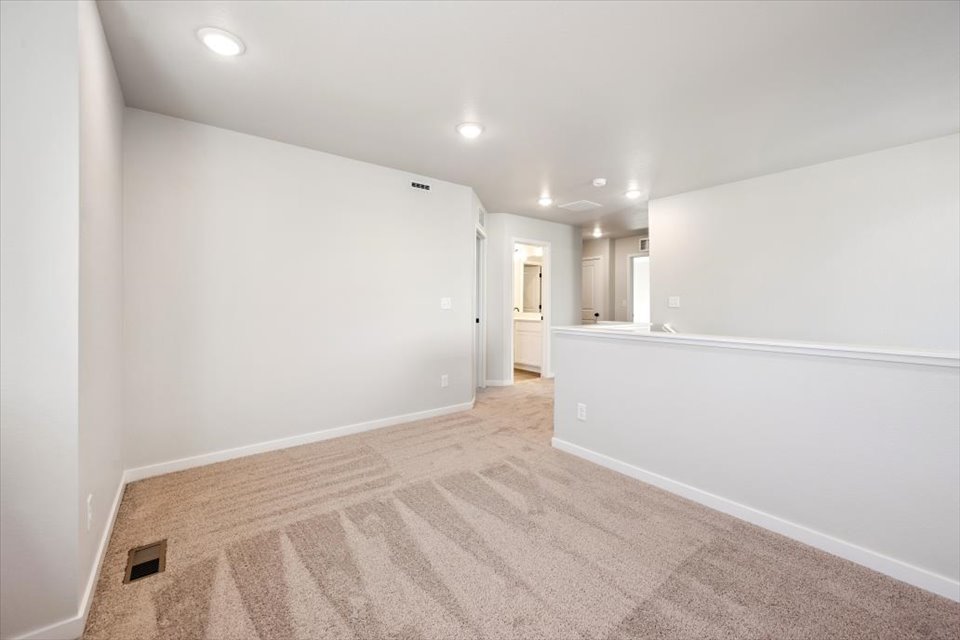 A hallway with white walls.