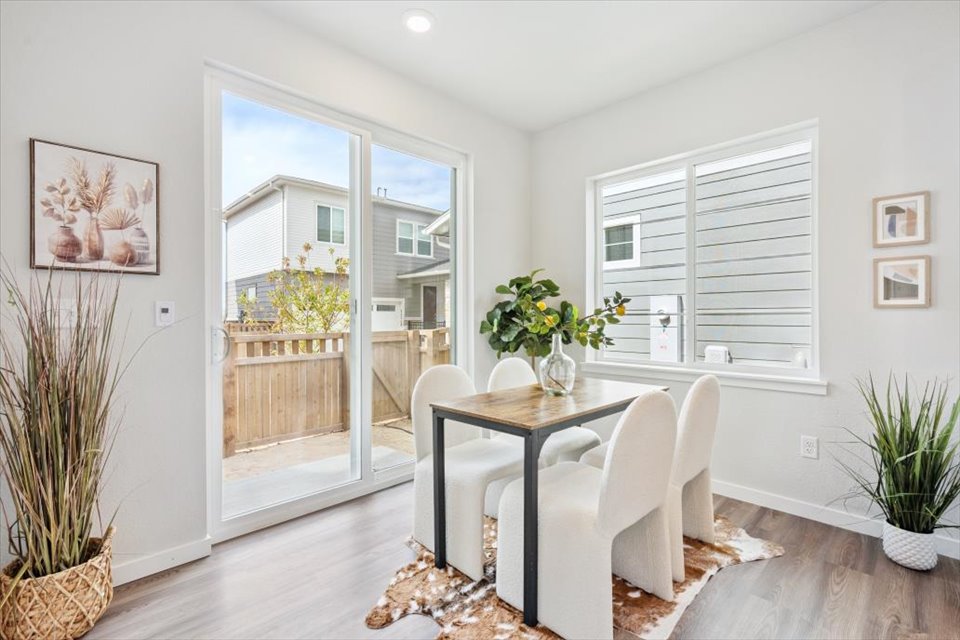 A dining room with a table and chairs.